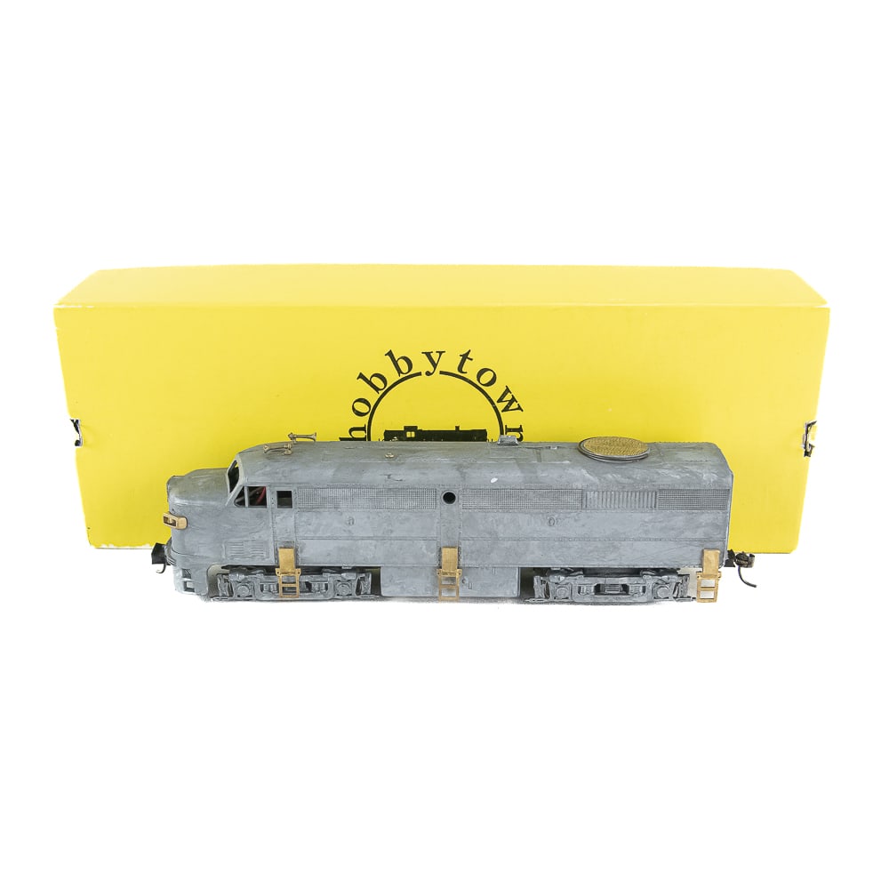 Hobbytown ALCO FA-02 HO Locomotive w Box: Hobbytown of Boston unpainted ALCO FA-02 metal body & power chassis kit w fly wheel drive FA-02. Very good overall condition with minimal cosmetic imperfections with some tarnish. Presents extremely