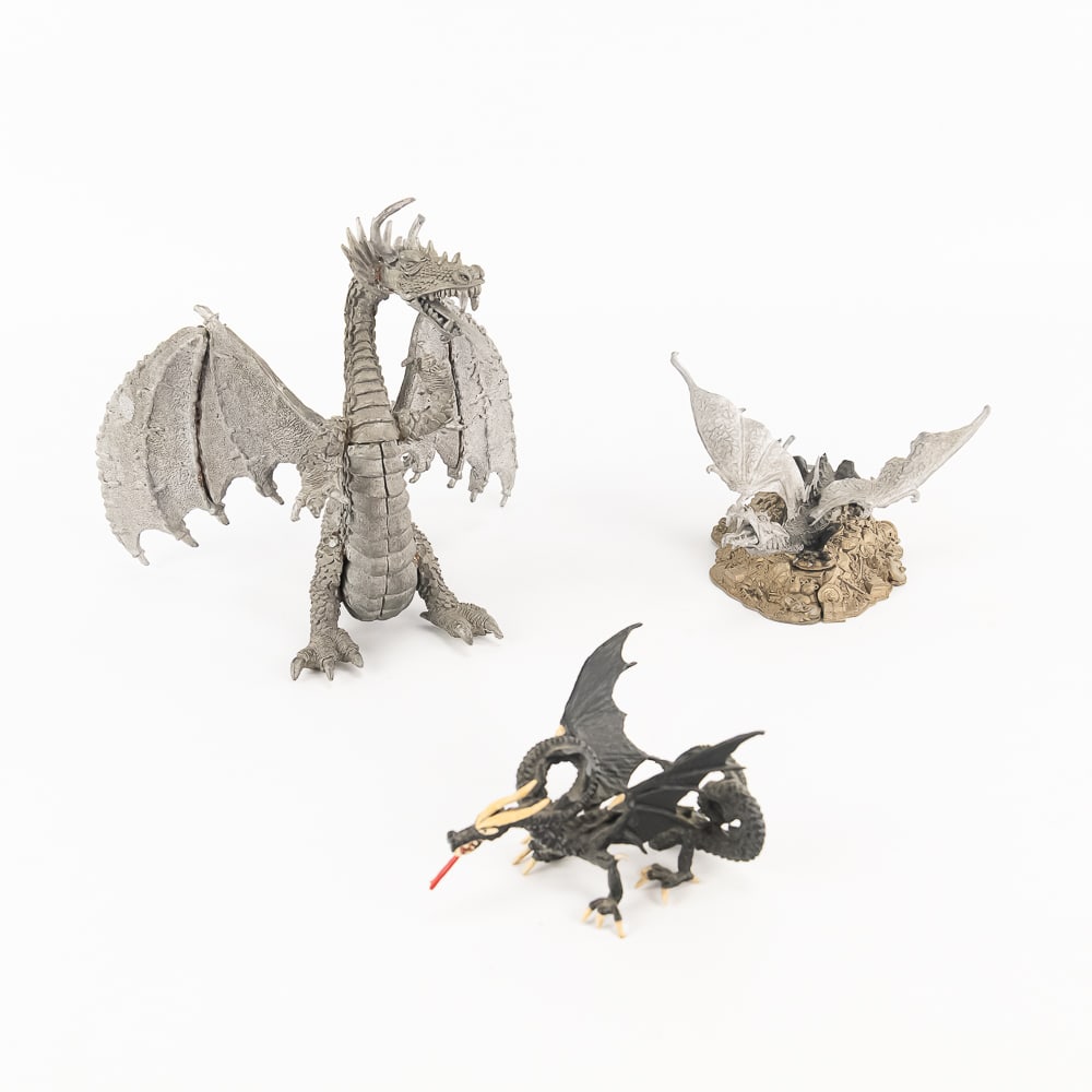 1980s Dungeons & Dragons Dragon Assortment: 1980s Dungeons and Dragons unpainted Greater Black Dragon on treasure hoard; pewter 8"t x 8.5"d x 8"l with glue and minor age broke off fin: Imperial Dragon on treasure (broken off back fin) 4"t x