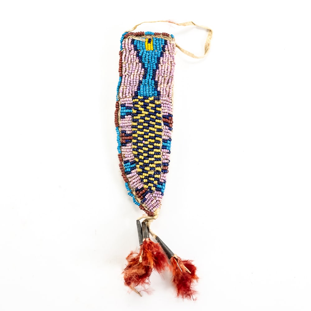Arapaho Beaded Knife Sheath: This late 19th-century Arapaho knife sheath is an exceptional example of Plains Indian beadwork from the Reservation period. Hand-stitched onto a brain-tanned leather substrate, the piece features a