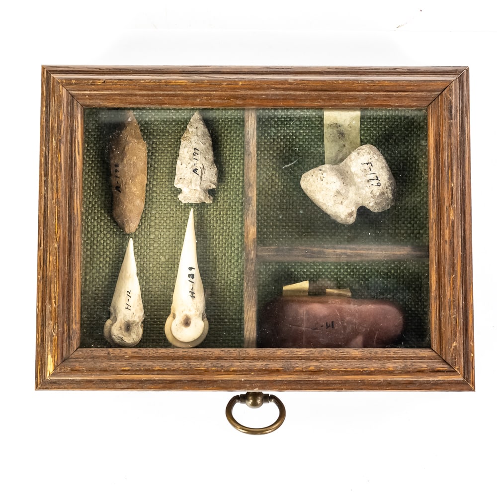 Native American Artifact Shadowbox: This collection features six prehistoric and historic Native American artifacts curated from various Midwestern sites. The assembly includes a miniature stone war club (F-179) and a secondary lithic