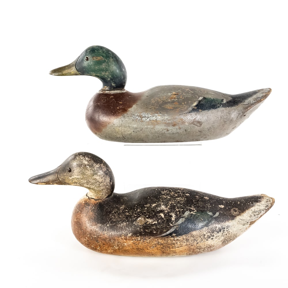 Pair of Mason Duck Decoys, Mallard & Hen: These are a classic pair of early 20th-century solid wood duck decoys, identified by their distinct form and "V" shaped neck carving as products of the Mason Decoy Factory of Detroit, Michigan. The pa
