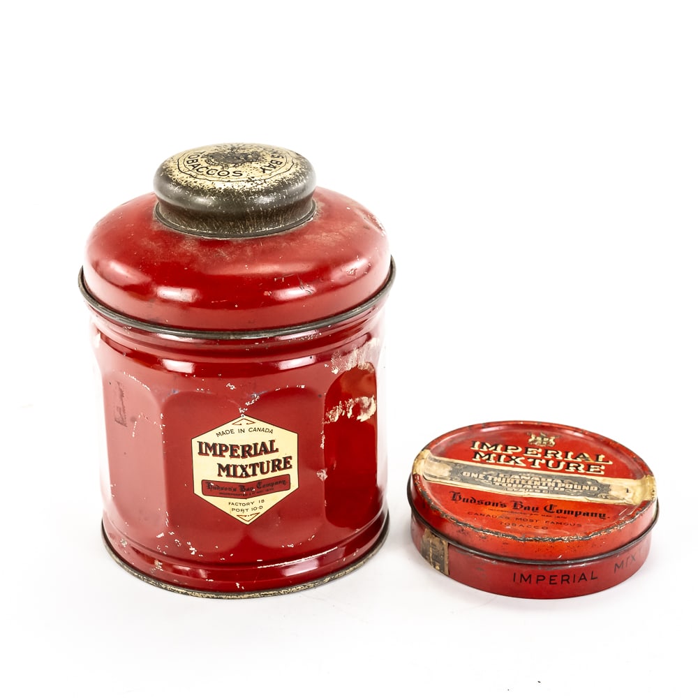 Vintage Hudson's Bay Tobacco Tin Lot: This lot features two mid-century Canadian tobacciana pieces from the Hudson’s Bay Company, featuring their renowned "Imperial Mixture." The humidor-style canister and smaller pocket tin
