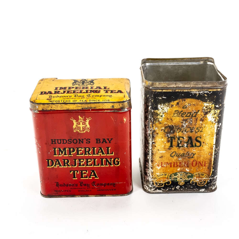 Vintage Hudson’s Bay Co. Tea Tins: These authentic pieces of Canadian mercantile history represent the storied legacy of the Hudson's Bay Company. The first is a vibrant red "Imperial Darjeeling Tea" tin, featuring the iconic HBC coat