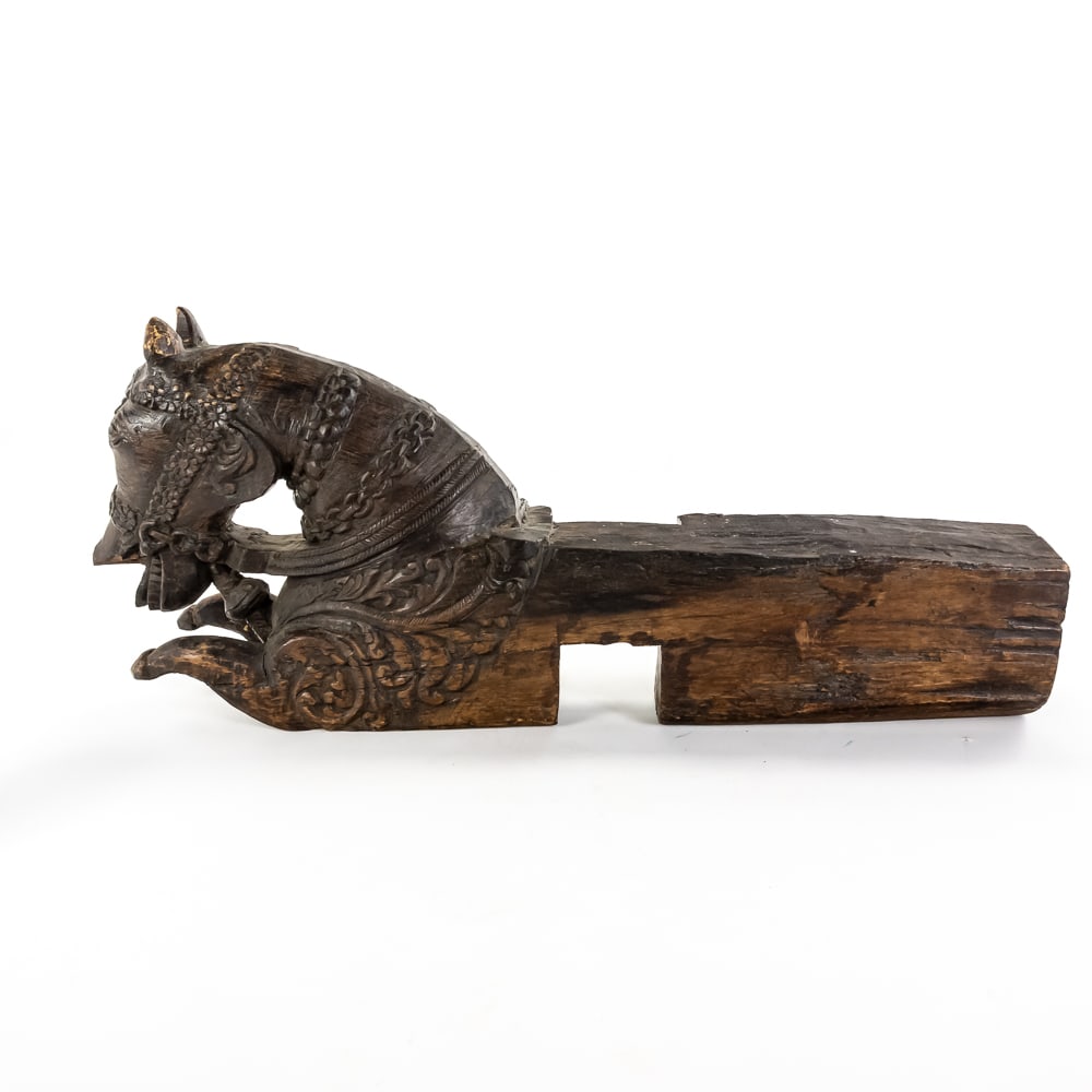 19th C. Carved Indian Teak Haveli Horse Corbel: This striking architectural element, likely a Northern Indian or Rajasthani "Haveli" bracket, is masterfully hewn from a single dense block of dark tropical hardwood. The piece features a caparisoned