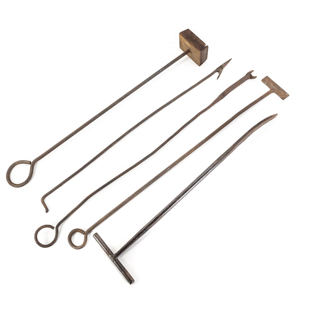 Antique Iron Branding & Forged Tools: This collection of five antique hand-forged iron tools features a standout "M" or "W" block branding iron, likely hailing from an American Western or mid-century agricultural setting. The set