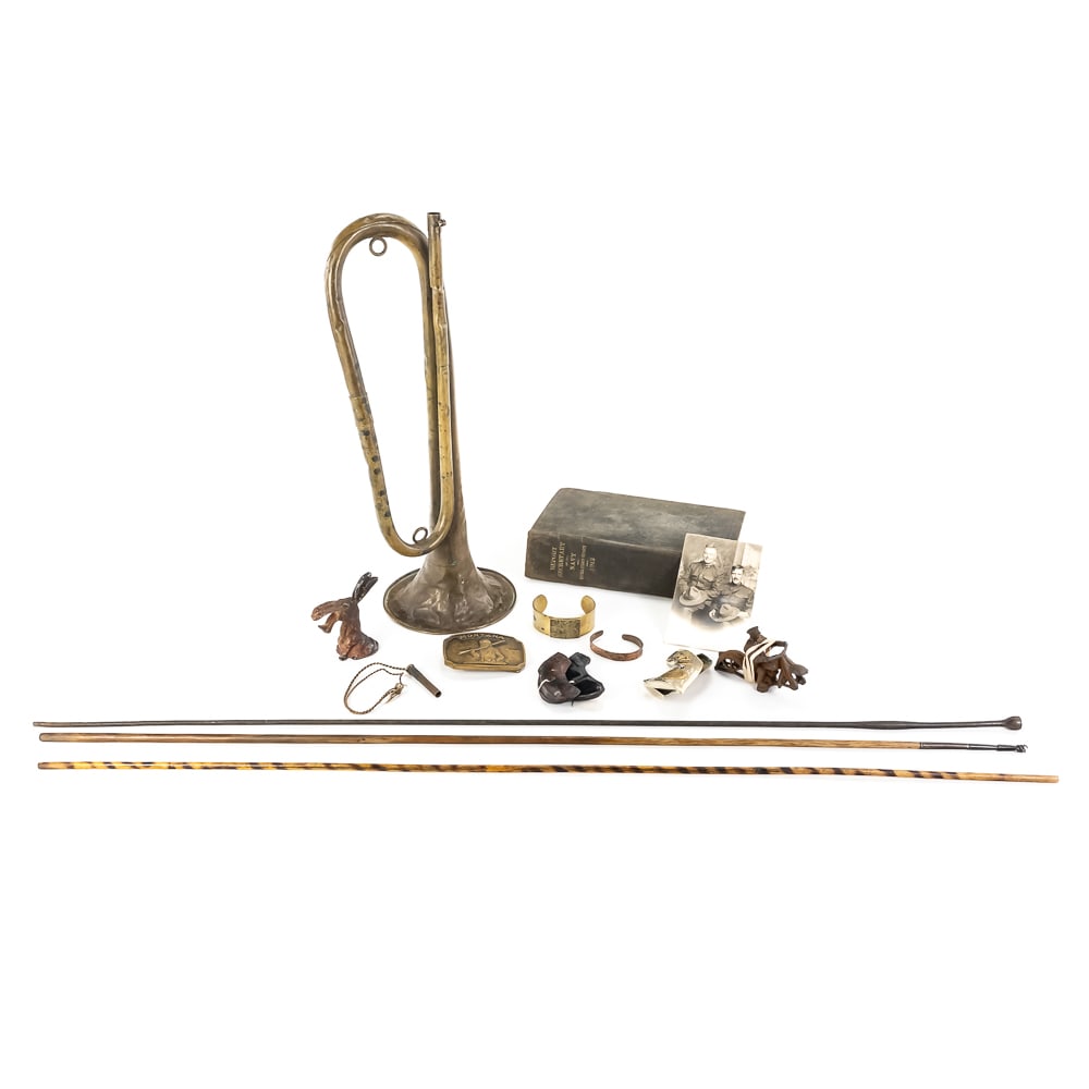 Early 20th Century Americana & Military Lot: This collection offers a fascinating cross-section of early 1900s history and mid-century Americana. At its core is a U.S. Regulation brass bugle, bearing faint "C.G. Conn" markings on the rim, a