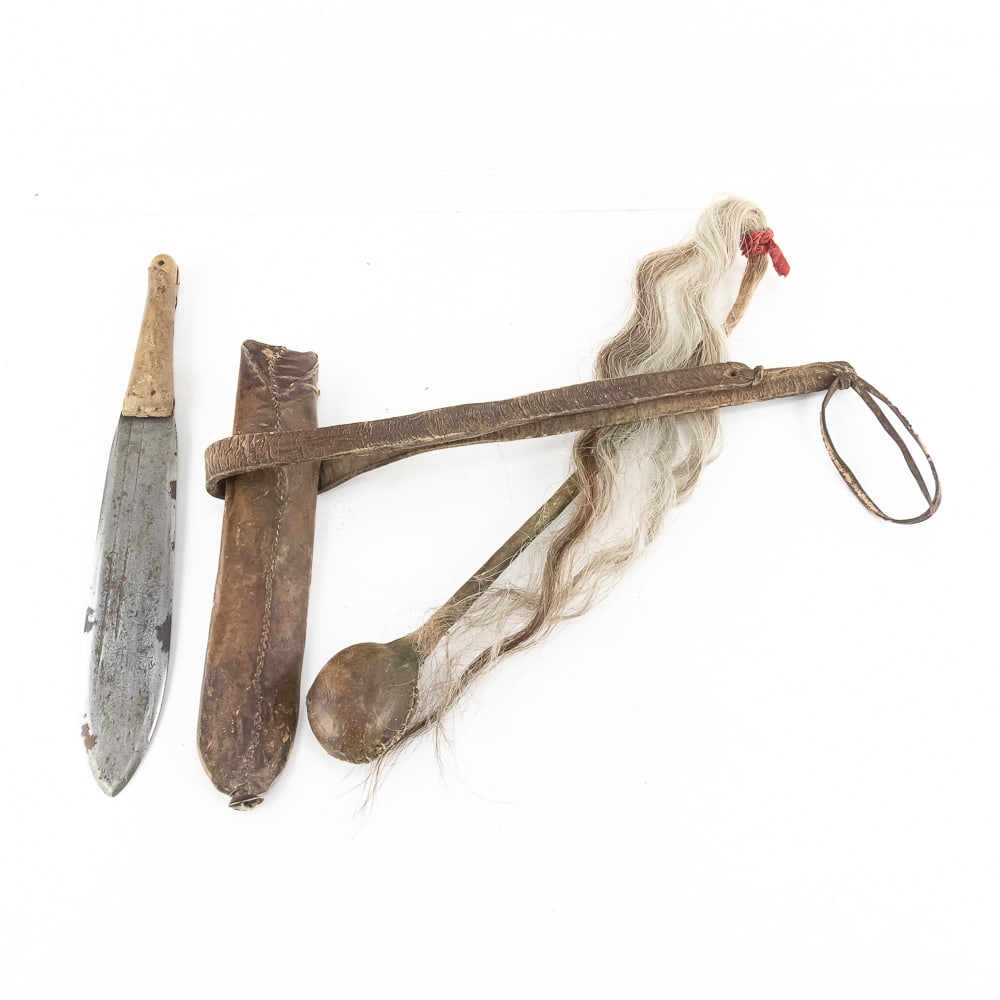 Plains-Style War Club & Scout Knife Set: This ethnographic lot features a "skull cracker" war club and a traditional straight-back knife with an integrated belt sheath. The war club consists of a stone head with a hand-stitched hide wrapping