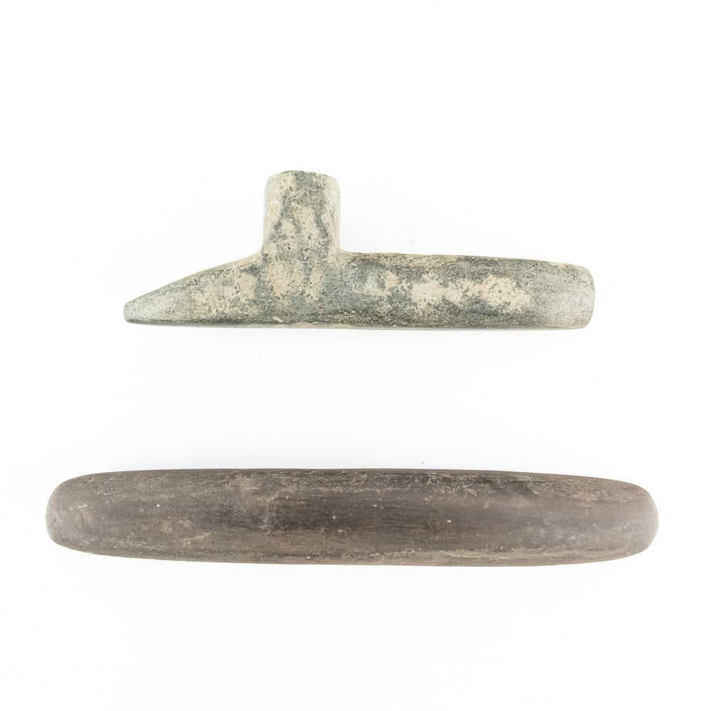 Mississippian Steatite Pipe & Celt: This lot features a significant Mississippian Period T-shaped pipe crafted from steatite (soapstone) and a finely polished stone celt. The pipe exhibits the classic "T" form typical of the