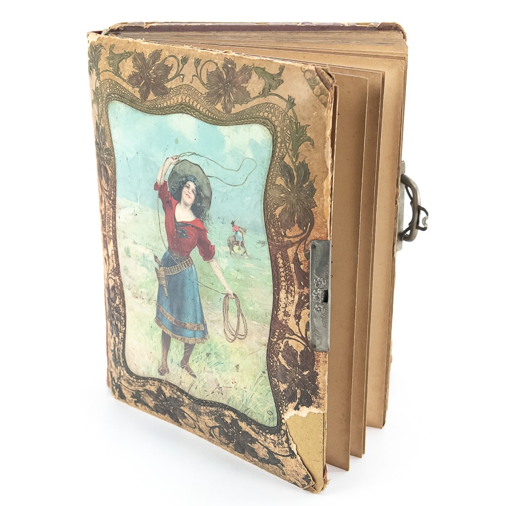 Victorian Cowgirl Litho Photo Album: This exceptional Victorian-era photo album is a quintessential piece of late 19th-century Americana, featuring a striking lithographed cover of a "frontier cowgirl" complete with a lasso and