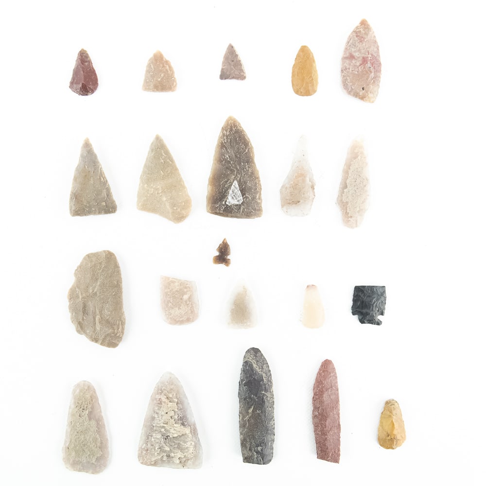 Collection of 22 Assorted Lithic Points: This impressive collection of 22 authentic lithic artifacts showcases a diverse range of prehistoric craftsmanship and material usage. The assemblage includes various styles such as triangular,