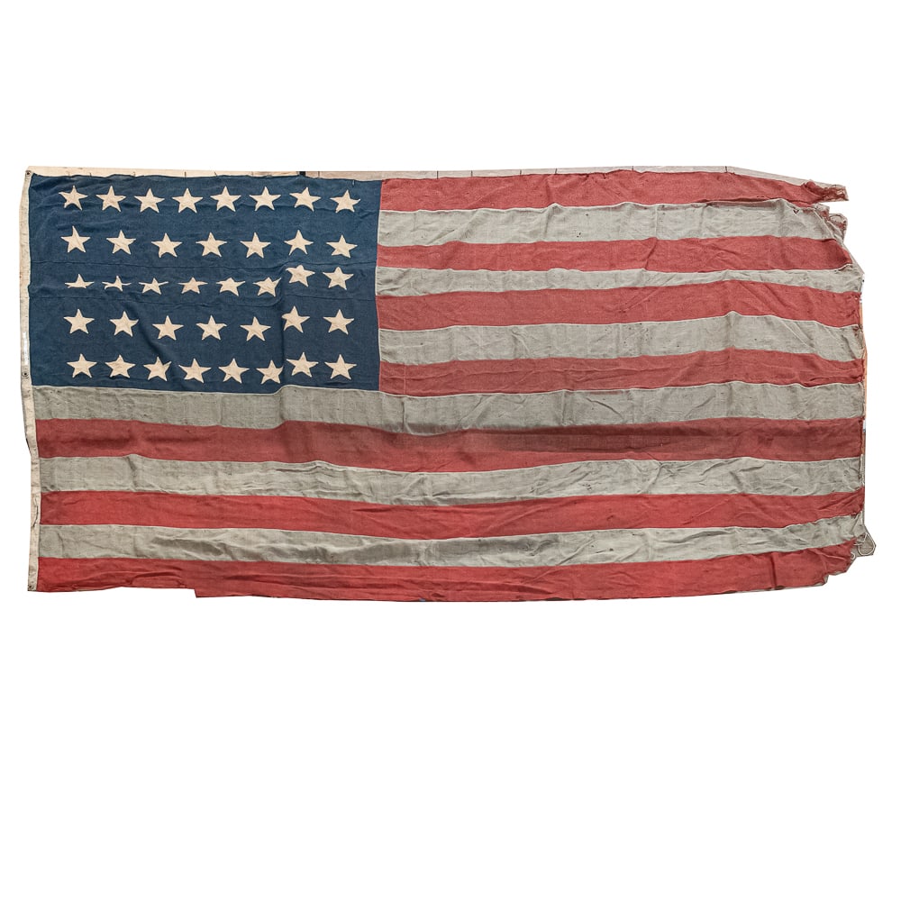 American 38-Star Ensign (Colorado Statehood): An exceptional, large-scale late 19th-century American 38-star national ensign, celebrating the admission of Colorado as the "Centennial State." Officially adopted on July 4, 1877, and remaining the