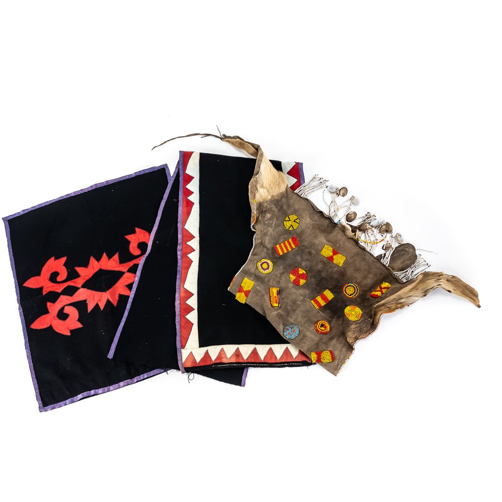 Three Indigenous-Style Textile/Hide Pieces: A striking collection of three distinct Indigenous-style textile pieces, featuring a hand-decorated animal hide and two applique fabric panels displaying characteristic Ainu geometric motifs. The