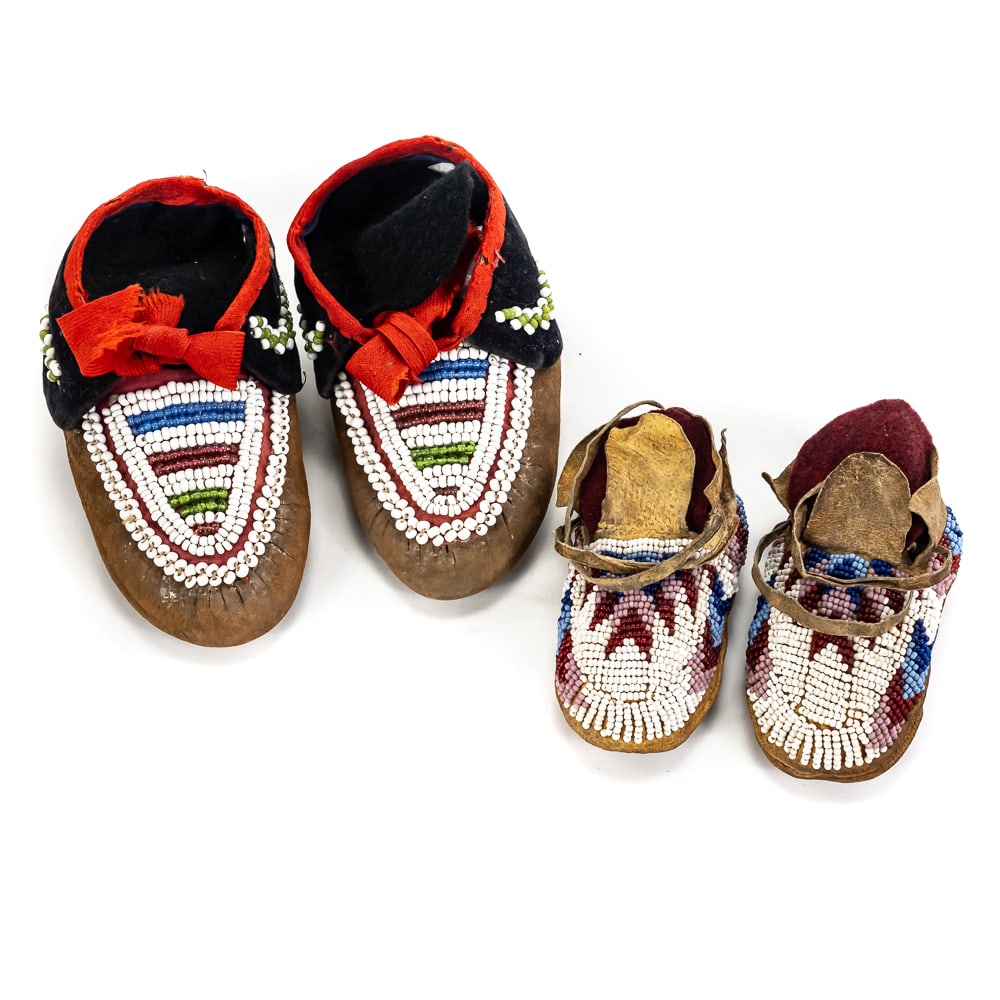 Two Pairs Beaded Moccasins-Child and Infant: This remarkable offering features two pairs of authentic, vintage Native American children's moccasins, meticulously crafted from brain-tanned leather and adorned with intricate glass seed beadwork.