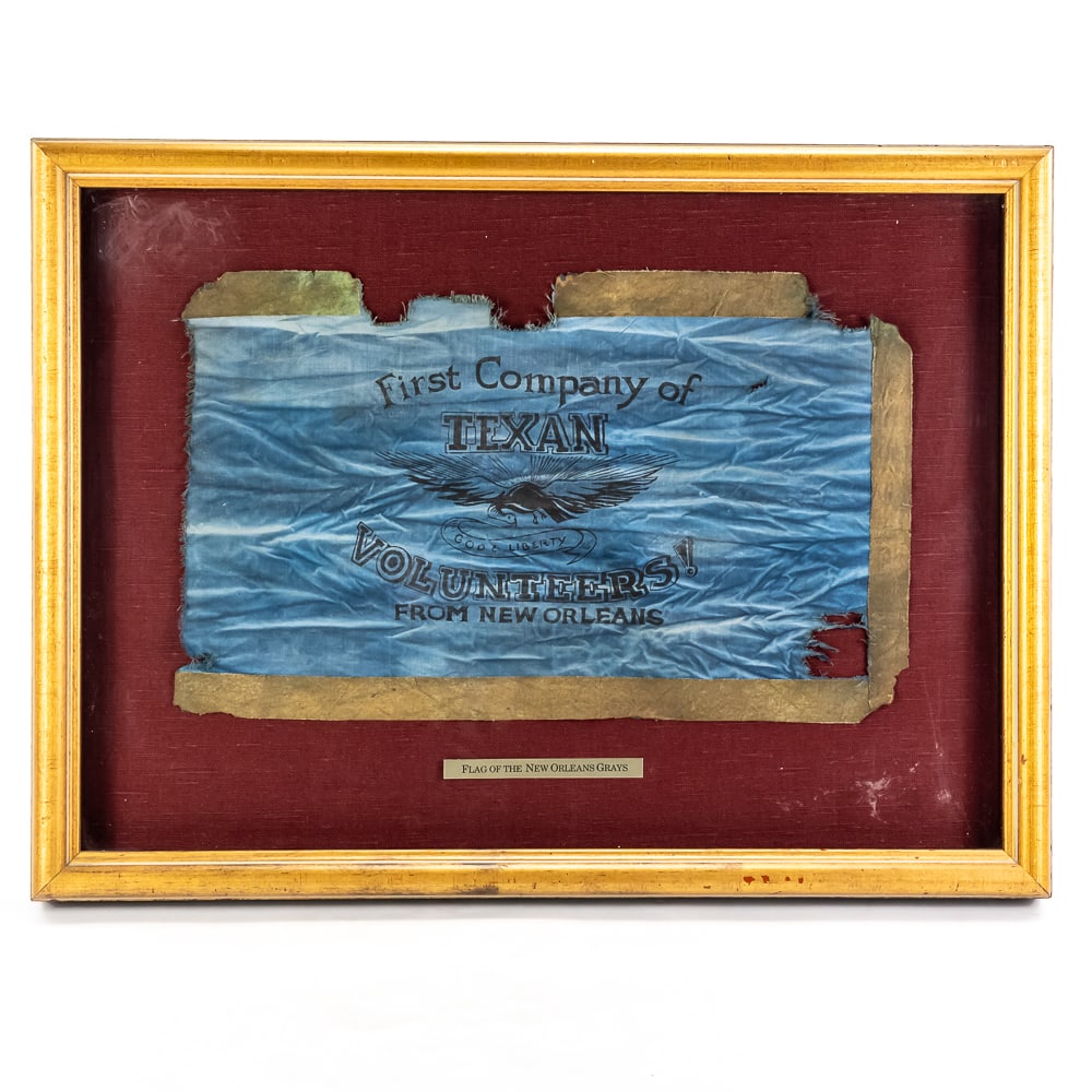 Framed First Co of Texan Volunteers: This framed, historical replica of the "Flag of the New Orleans Grays" captures the spirit of the Texas Revolution. Featuring a light blue field with a central eagle emblem and the text "First