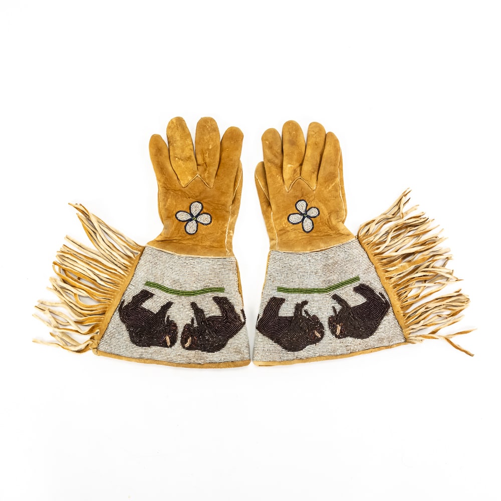 Native American Style Beaded Bison Gauntlets: This impressive pair of buckskin gauntlets showcases striking Native American styling, featuring meticulously crafted seed beadwork on the wide cuffs that depicts two bison walking along a green