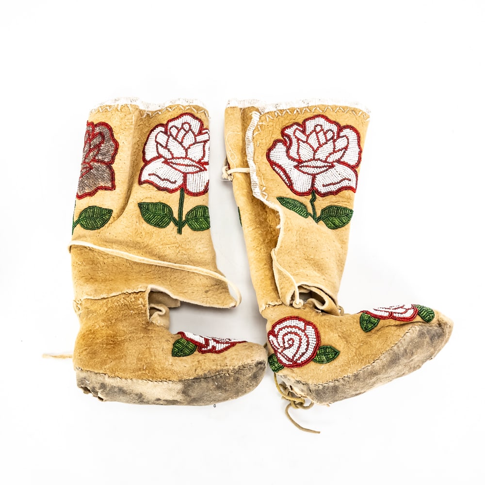 Beaded Rose Buckskin Moccasin Boots: These stunning Native American style tall moccasin boots showcase the exquisite artistry of traditional floral beadwork. Crafted from soft, brain-tanned buckskin, the boots feature vibrant,
