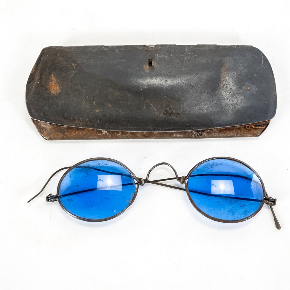 Antique Blue Glass Wire Spectacles: A fascinating piece of 19th-century eyewear, these antique spectacles feature striking, deep cobalt blue glass lenses set in a delicate, dark metal wire frame. While visually identical to standard