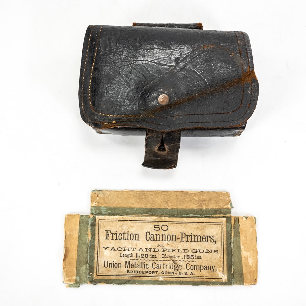 CS Revolver Pouch & Friction Primer Box Face: This lot features a fascinating piece of Civil War era ordnance history: a Confederate States (C.S.) pattern leather revolver pouch paired with a vintage Union Metallic Cartridge Company friction