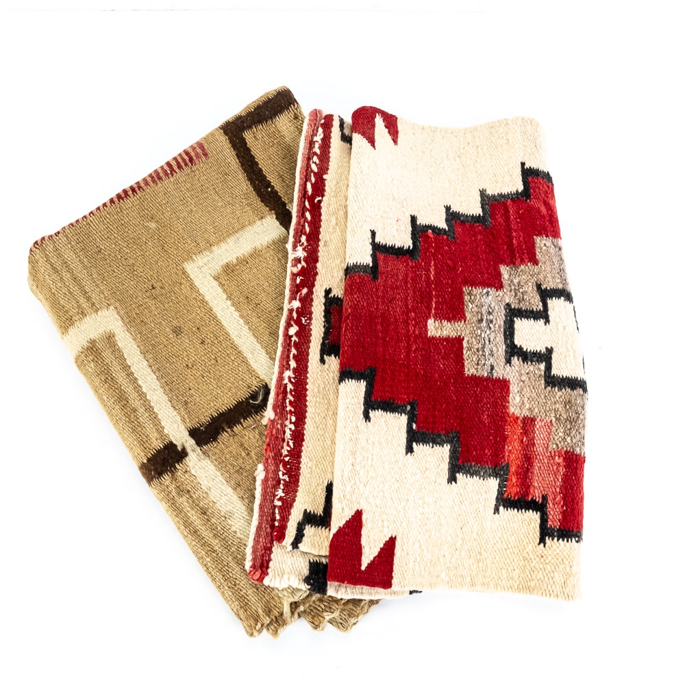 Two Navajo Style Southwest Woven Rugs: This offering features a pair of vibrant Navajo-style Southwest woven textiles, showcased in two distinct geometric designs. The smaller rug showcases a traditional eye-dazzler or Ganado-inspired aest