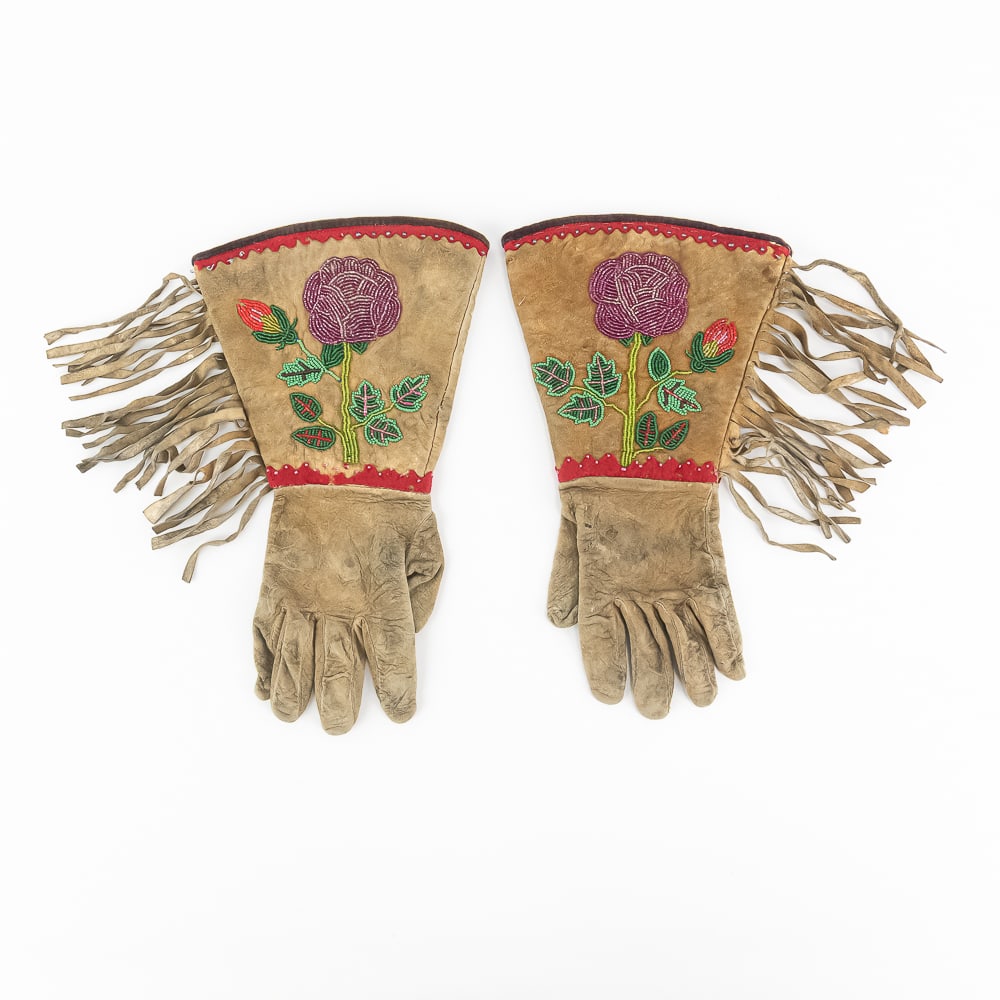 Pair of Beaded Native American Gauntlets: This stunning pair of vintage Native American style buckskin gauntlets showcases exquisite floral beadwork, featuring a prominent purple rose motif with green leaves and a red bud on each cuff.