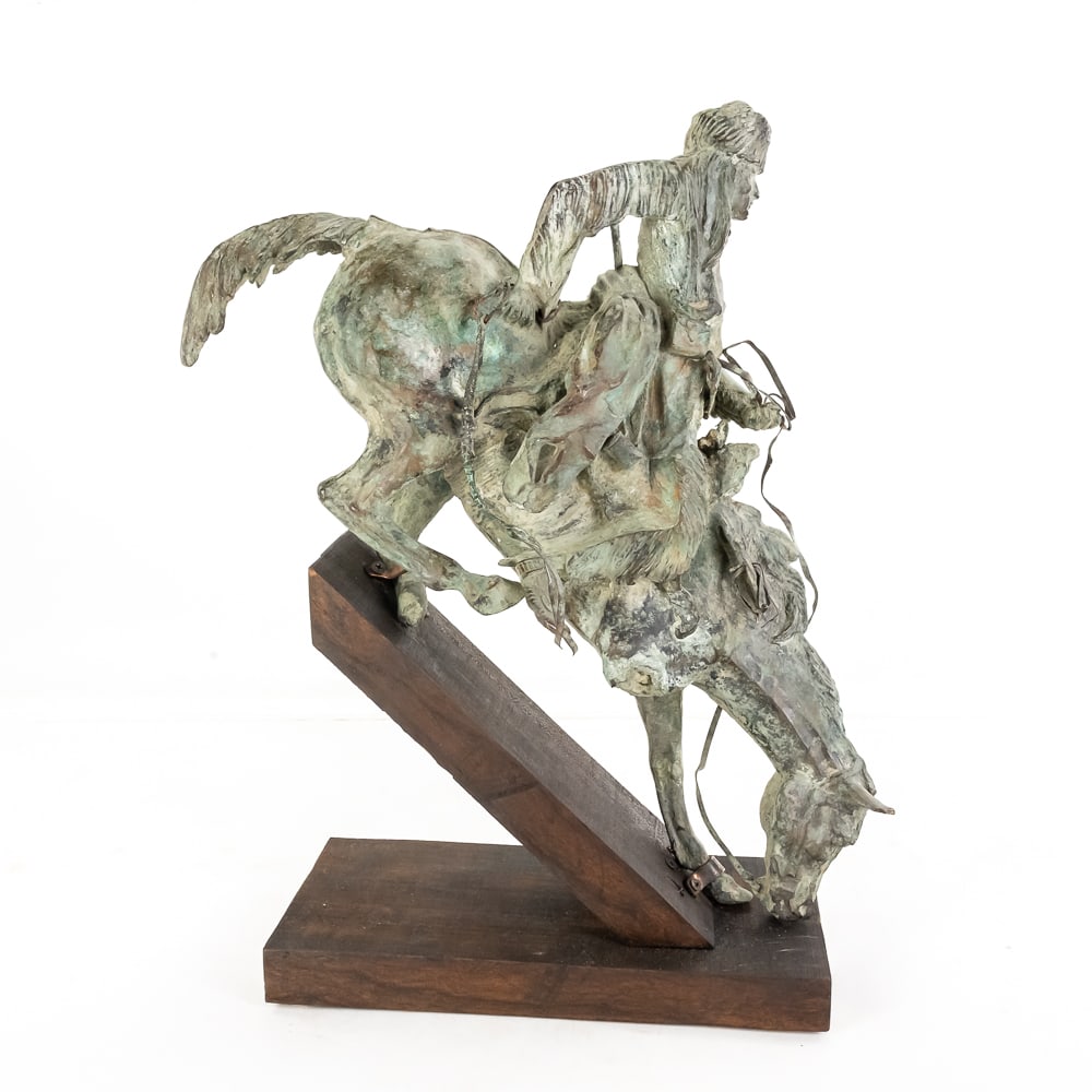 Remington Mountain Man Bronze Statue: This heavy bronze casting, modeled after Frederic Remington’s iconic 1903 masterpiece "The Mountain Man," captures the high-stakes verticality of a frontier trapper and his horse navigating a