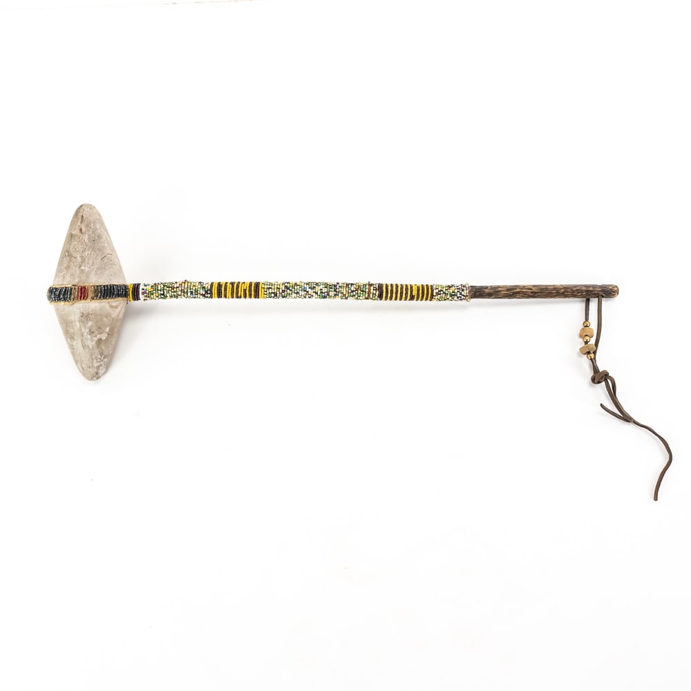 Native American Beaded Stone War Club: This striking Plains-style war club features a bi-pointed, hand-ground stone head securely lashed to a wooden handle with a traditional hide wrap. The craftsmanship is highlighted by the intricate