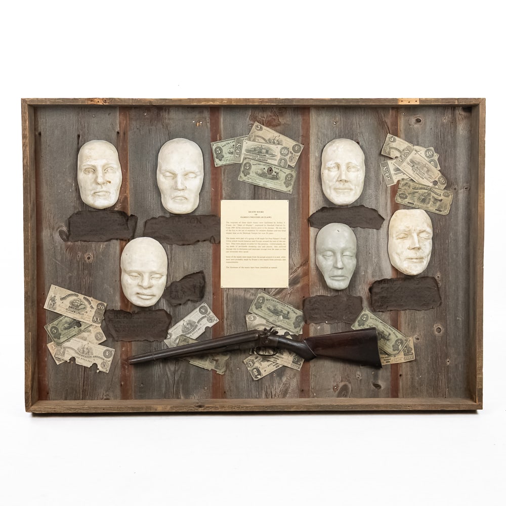 Western Outlaw Death Masks Display: This is an extraordinary, one-of-a-kind relic of Western showmanship: a set of seven death masks of famous Western outlaws. These masks were fashioned by Arthur V. Fraser, the "Dean of Display," for