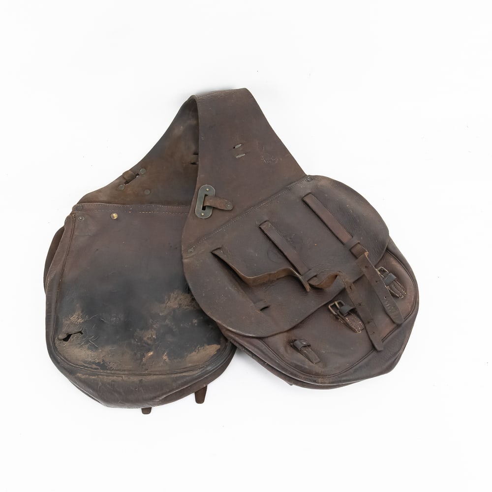 Antique US Cavalry Leather Saddlebags: These are a classic set of WWI-era US Military cavalry saddlebags, likely the Model 1904 pattern, crafted from heavy russet leather. While no specific maker's mark or manufacturer stamp was located