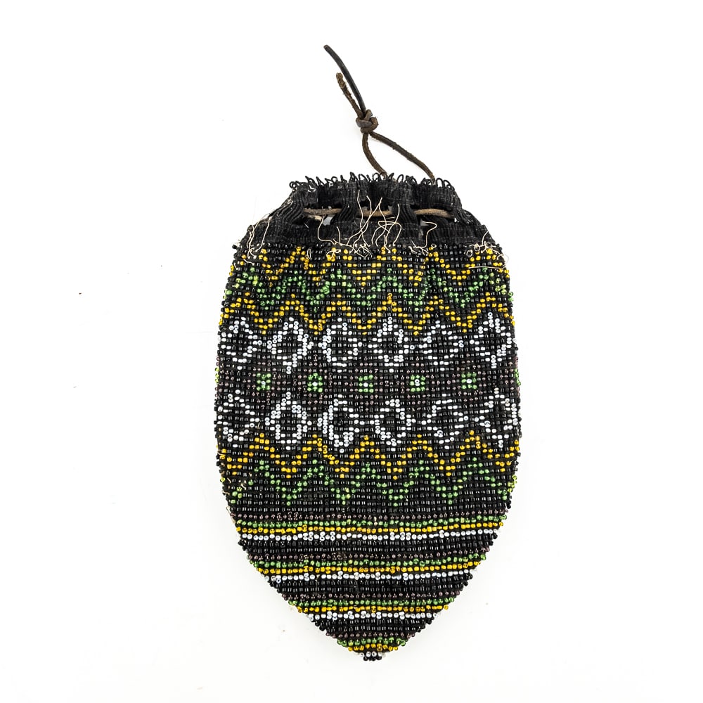 Eastern Woodland Beaded Bag: This is an eastern Woodlands beaded purse possibly dating to the late 19th century Or early 20th century. It features intricate beadwork and a netted geometric design using colors such as black white