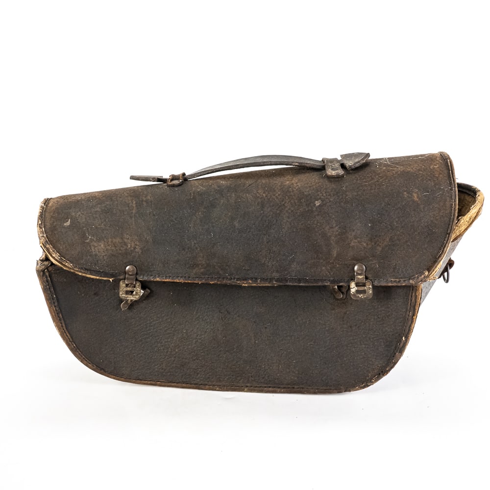 Antique Leather Saddlebag: Antique leather saddlebag with snap lock mechanism with "JLT" on the hardware. Approximately 9"t x 16"l and in good overall condition with age and wear including discoloration, some edges splitting