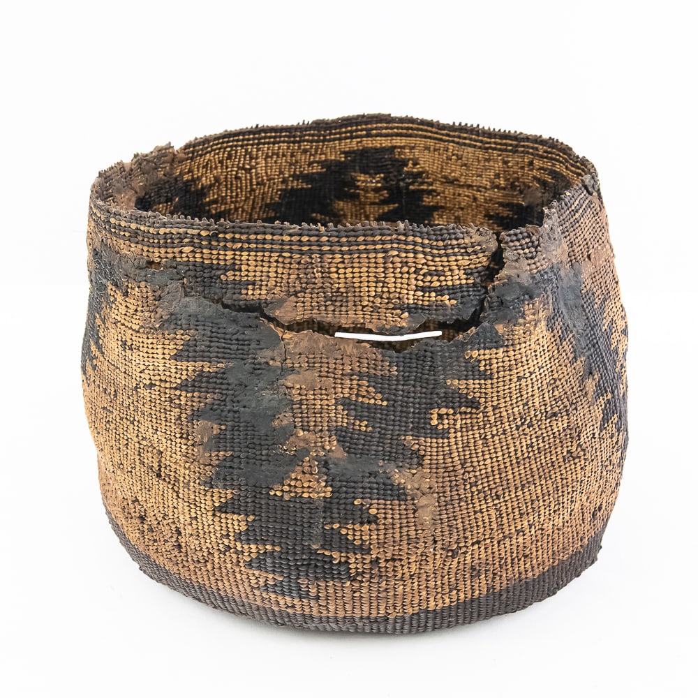 Northern California Native Porridge Bowl: This is a Klamath Porridge basket likely from the late 19th or early 20th century. It showcases traditional weaving techniques and design. The basket features a cylindrical shape slightly tapering at