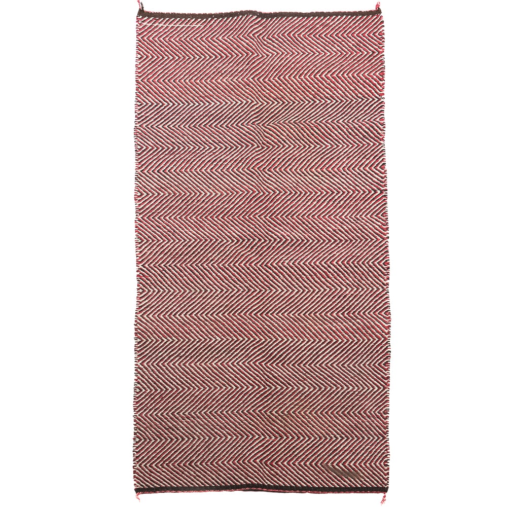 Double Saddle Blanket: Double saddle blanket. Woven textile wool or wool blend featuring a repeating red, white and black chevron pattern with dark borders. Tightly woven, and durable. Overall in good condition with only