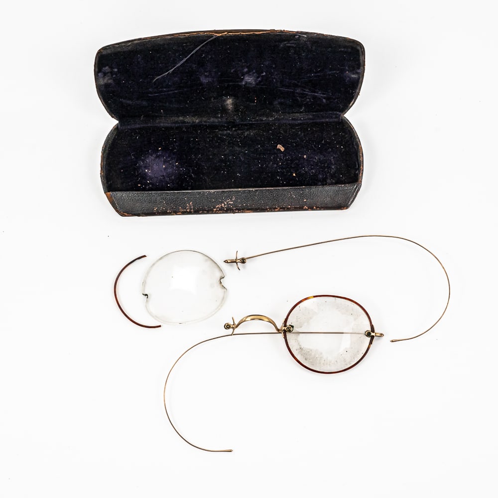 Civil War Era Eyeglasses In Case: These glasses have one broken frame and one arm is loose. The frame is gold-filled. The case is steel with leather cover and purple velvet lining. Leather is pealing off at the hinges. These glasses