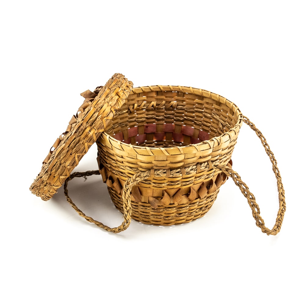 1940s NE Coast Penobscot Basket: This is a Penobscot basket circa 1940s crafted from ash splints and sweet grass. It features a round shape with a fitted lid, adorned with distinctive porcupine or curly cue weave pattern on both the