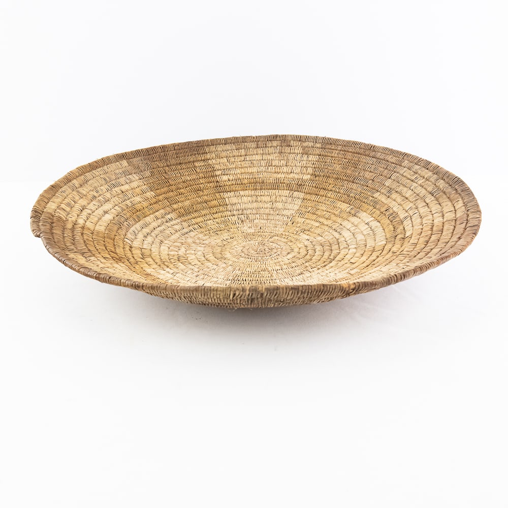 1920s Southern California Coil Mission Basket: Coiled hand woven basket from Southern California, circa 1920. Often referred to as a “Mission” basket. This basket when viewed from the bottom coils clockwise, which means that it was lik