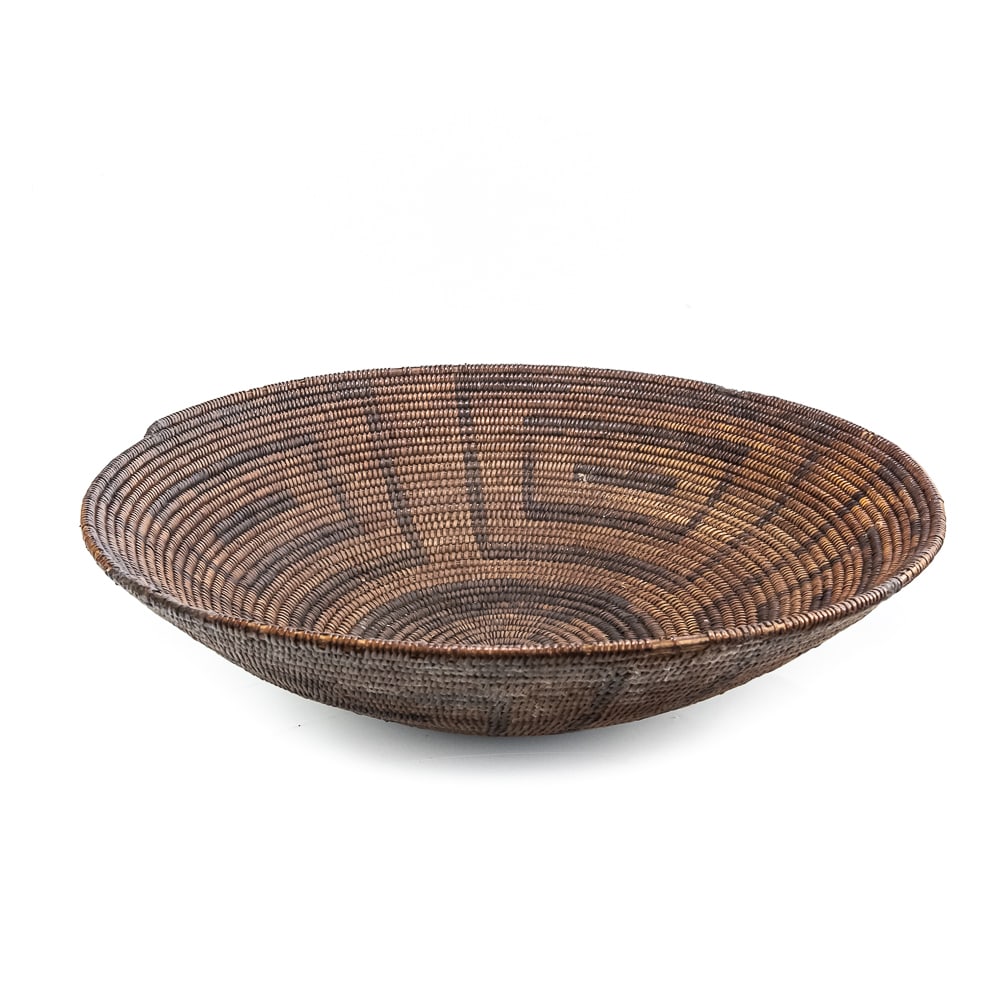 1920s Akimel O’odham Pima Coil Basket: Large Akimel O’odham Pima bowl dating circa 1920s features a closed coil weave of natural fibers possibly willow, devil's claw and bear grass. Rounded base. The bowl exhibits a wide and deep for