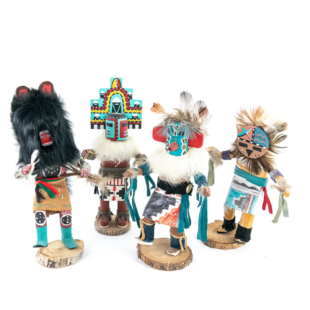 Hand-Carved Kachina Doll Collection (4): This curated assembly of four hand-carved Kachina (Katsina) dolls represents a vibrant cross-section of Southwestern ceremonial artistry. The lot features a Crow Mother with her distinctive