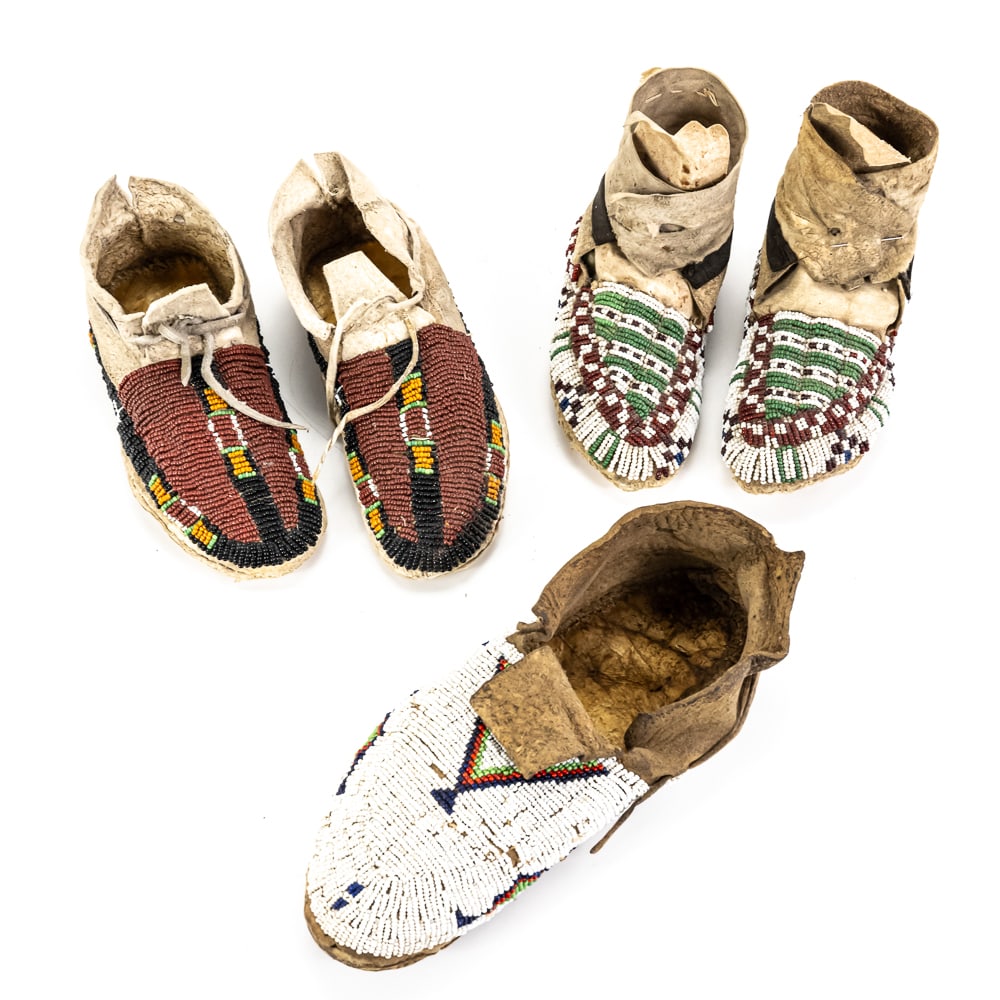 5pc Antique Beaded Native Moccasins: This exquisite collection of Plains-style beadwork showcases the meticulous craftsmanship of late 19th to early 20th-century indigenous artisans. The lot includes two pairs of child-sized moccasins