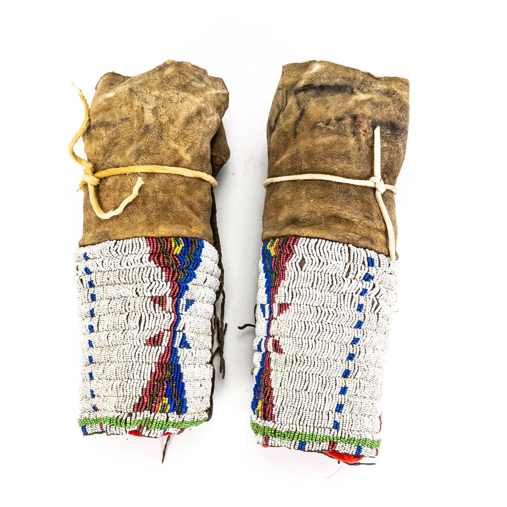 Antique Native American Beaded Cuffs Pair: These striking Plains-style hide cuffs, likely dating from the late 19th to early 20th century, were traditionally worn as wrist gauntlets or arm bands, though similar styles were occasionally utilize
