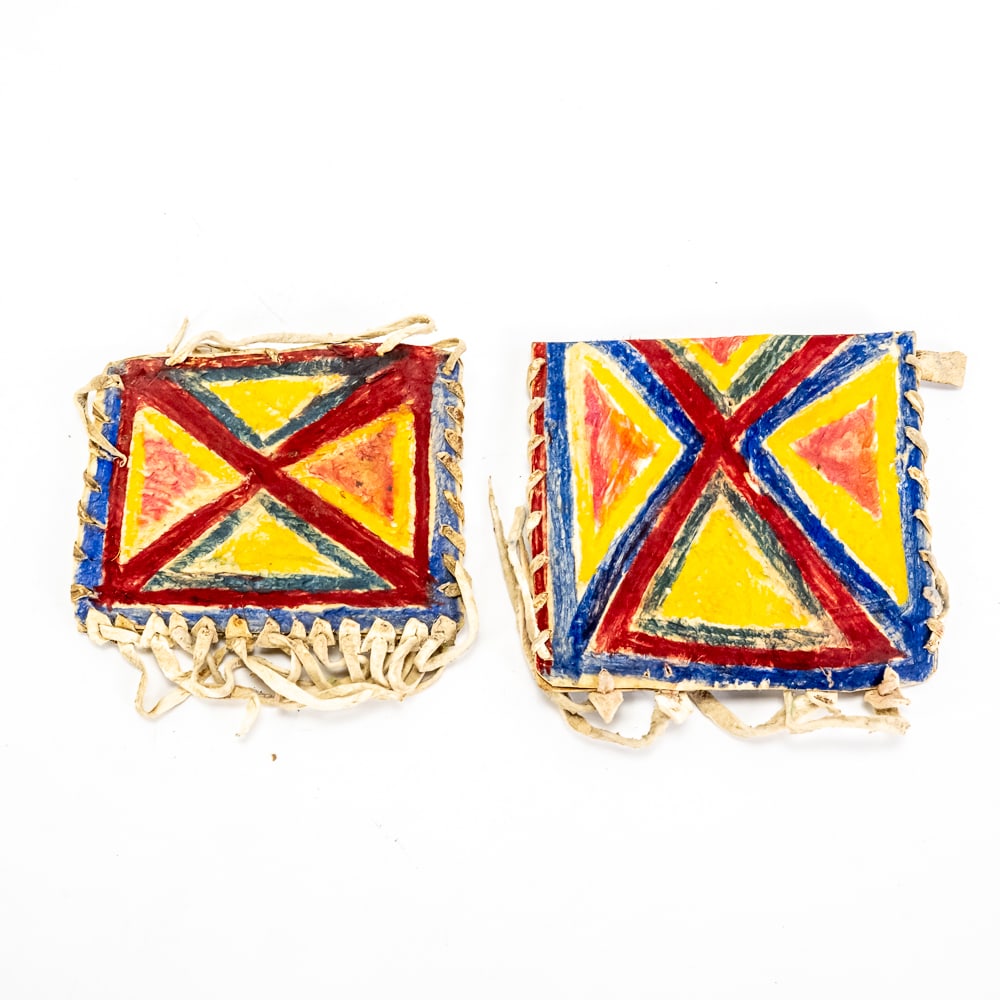 Pair of Hand-Painted Rawhide Envelopes: These vibrant rawhide envelopes, or "parfleche" style pouches, are classic examples of Great Plains decorative tradition, likely dating to the mid-20th century. Crafted from stiff, processed rawhide,