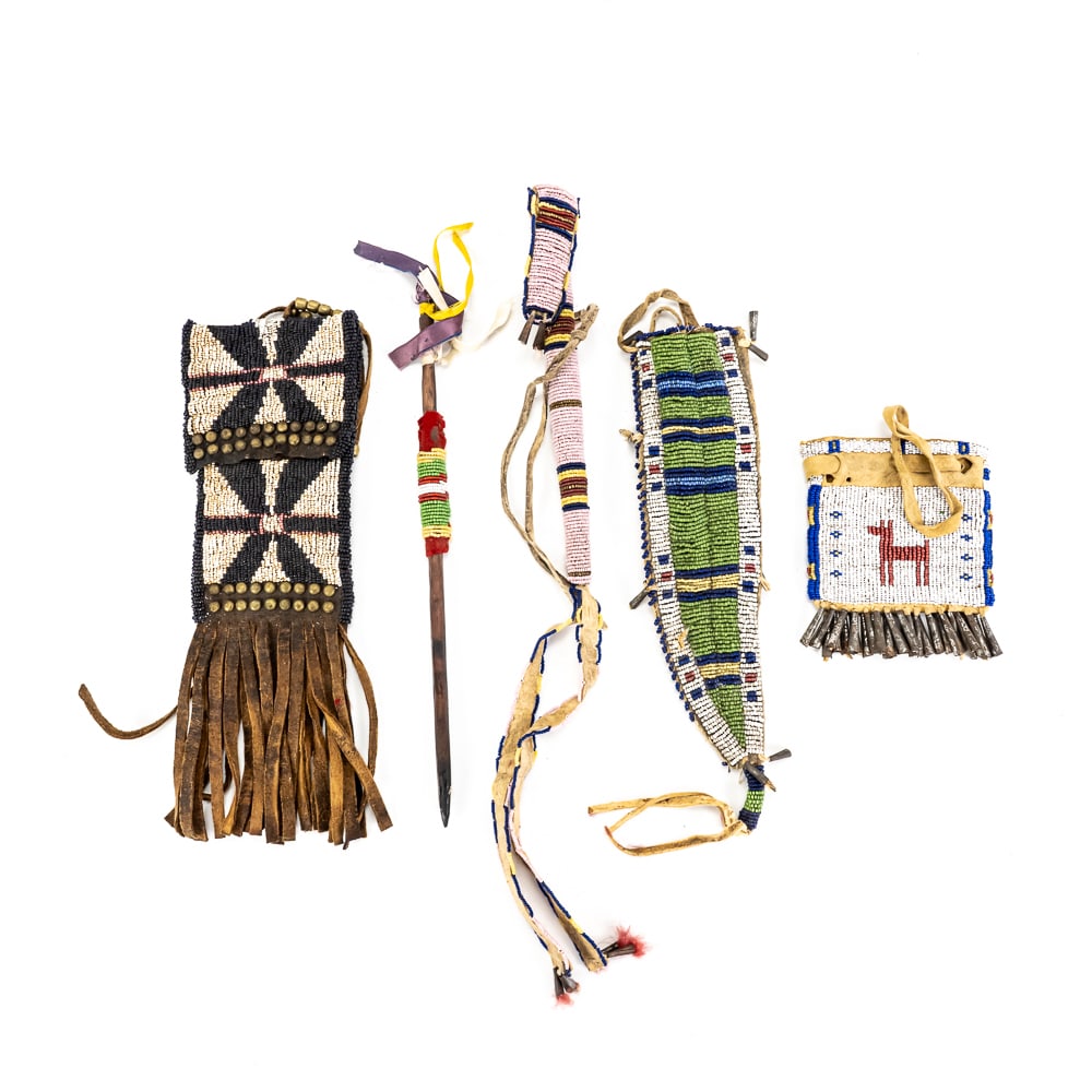 Native American Style Beaded Item Group (5): This collection features a variety of traditional Plains-style artistry, including a small medicine pouch with a "spirit figure" and "greasy blue" trim, a green-ground knife sheath with metal