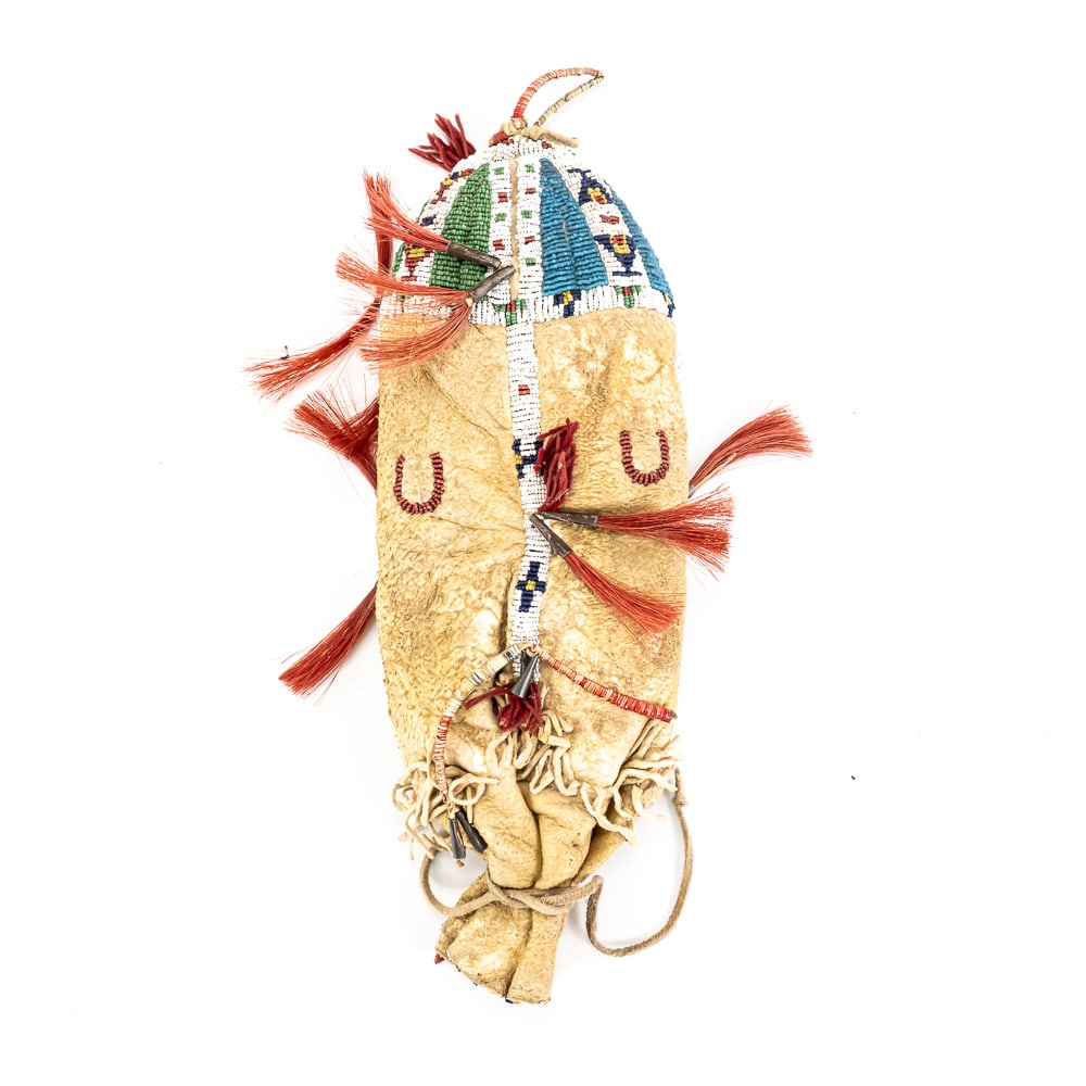 Beaded Reservation Era 1880-1920 Plains Indian Bag: This striking Plains-style hide bag features intricate seed beadwork in vibrant blues, greens, and reds, accented by horseshoe motifs and tin cone "jingles." While some accents appear to be traditiona