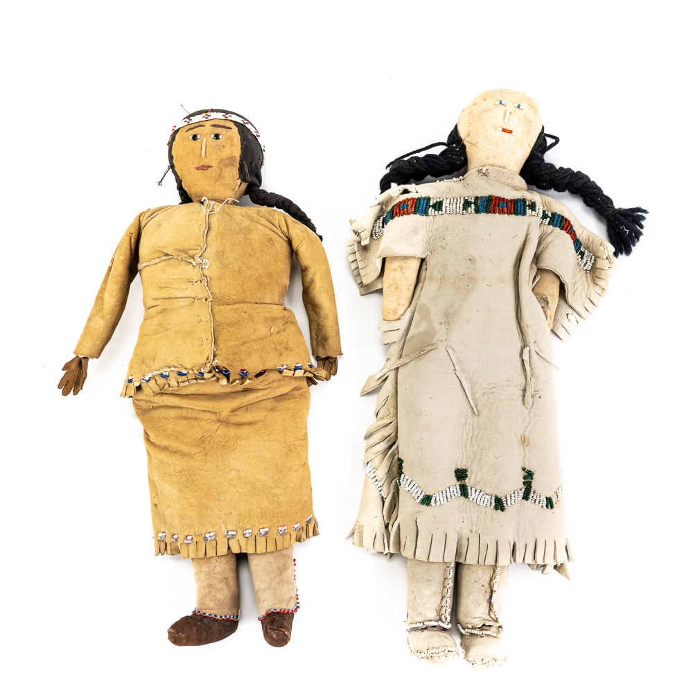 Native American Style Beaded Buckskin Dolls (2): This pair of handcrafted Native American style dolls features traditional buckskin attire adorned with intricate glass beadwork. The larger 14" doll showcases a light tan dress with a multi-colored