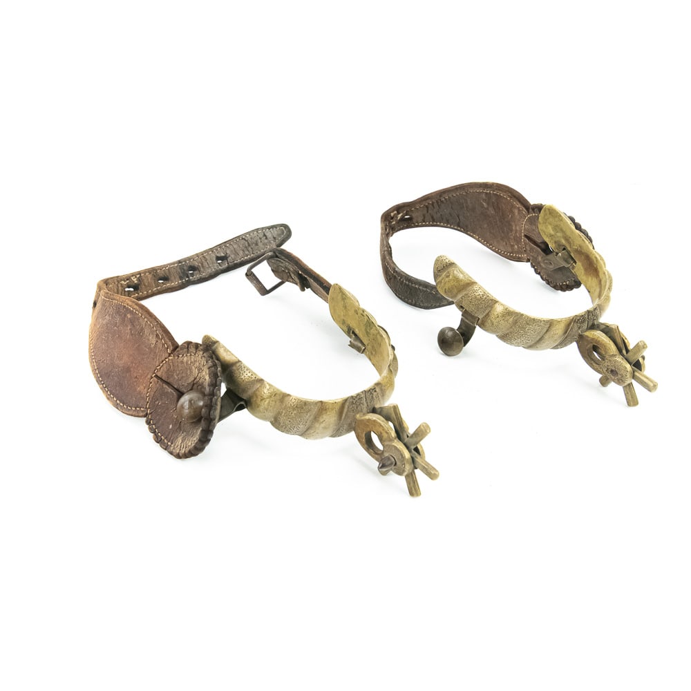 Vintage Engraved Brass Western Spurs Pair: This pair of Western spurs showcases the classic artistry of the mid-20th century, likely dating from the 1940s to the 1950s. Crafted from a heavy brass alloy, the heel bands feature a bold, deep-cut