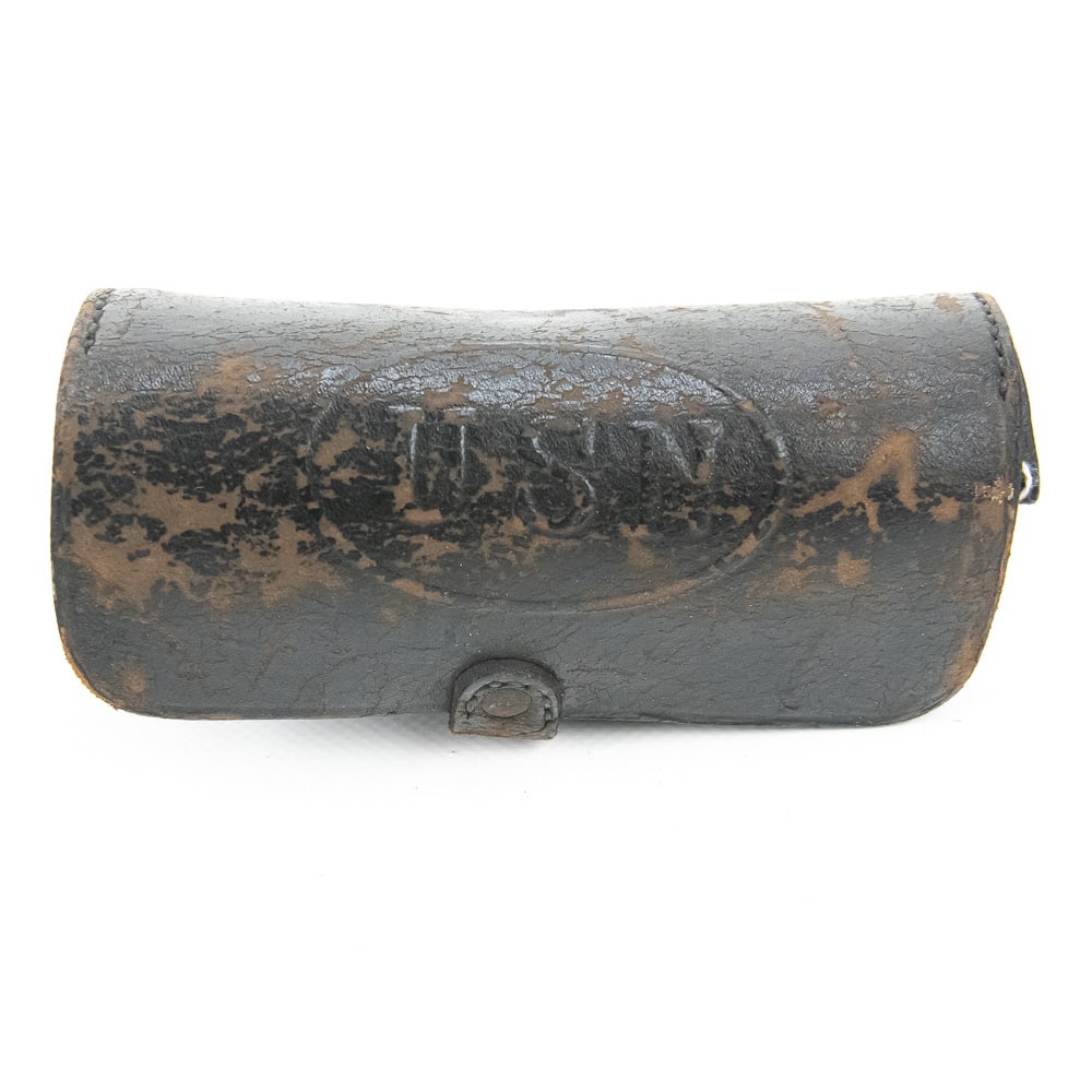Antique USN Leather Service Pouch: This is a specialized piece of American naval history: a heavy-duty blackened leather service pouch or ammunition box featuring a distinct embossed "USN" within an oval on the top lid. While often