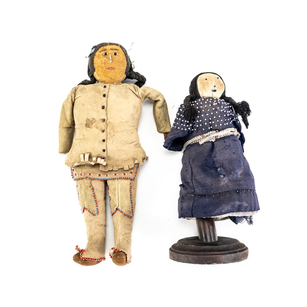 Pair of Native American Style Beaded Dolls: These handcrafted dolls showcase traditional Great Plains or Plateau style artistry, likely dating from the mid-20th century. The larger male figure is meticulously crafted from buckskin or sueded