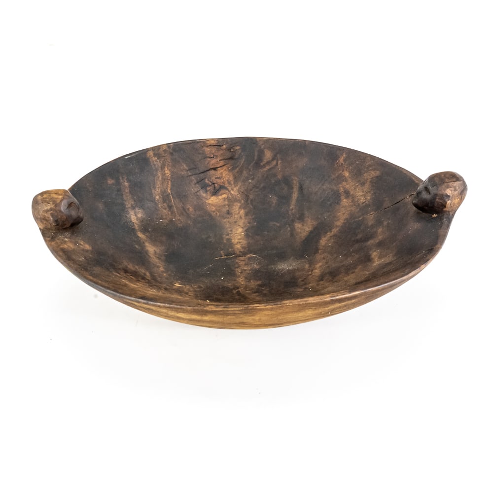 Carved Wood Figural Dough Bowl: This striking hand-carved wooden bowl, likely of West Africa (possibly Baule or Guro from Côte d'Ivoire) or Oceanic (Solomon Islands) origin, features a shallow, elongated oval form