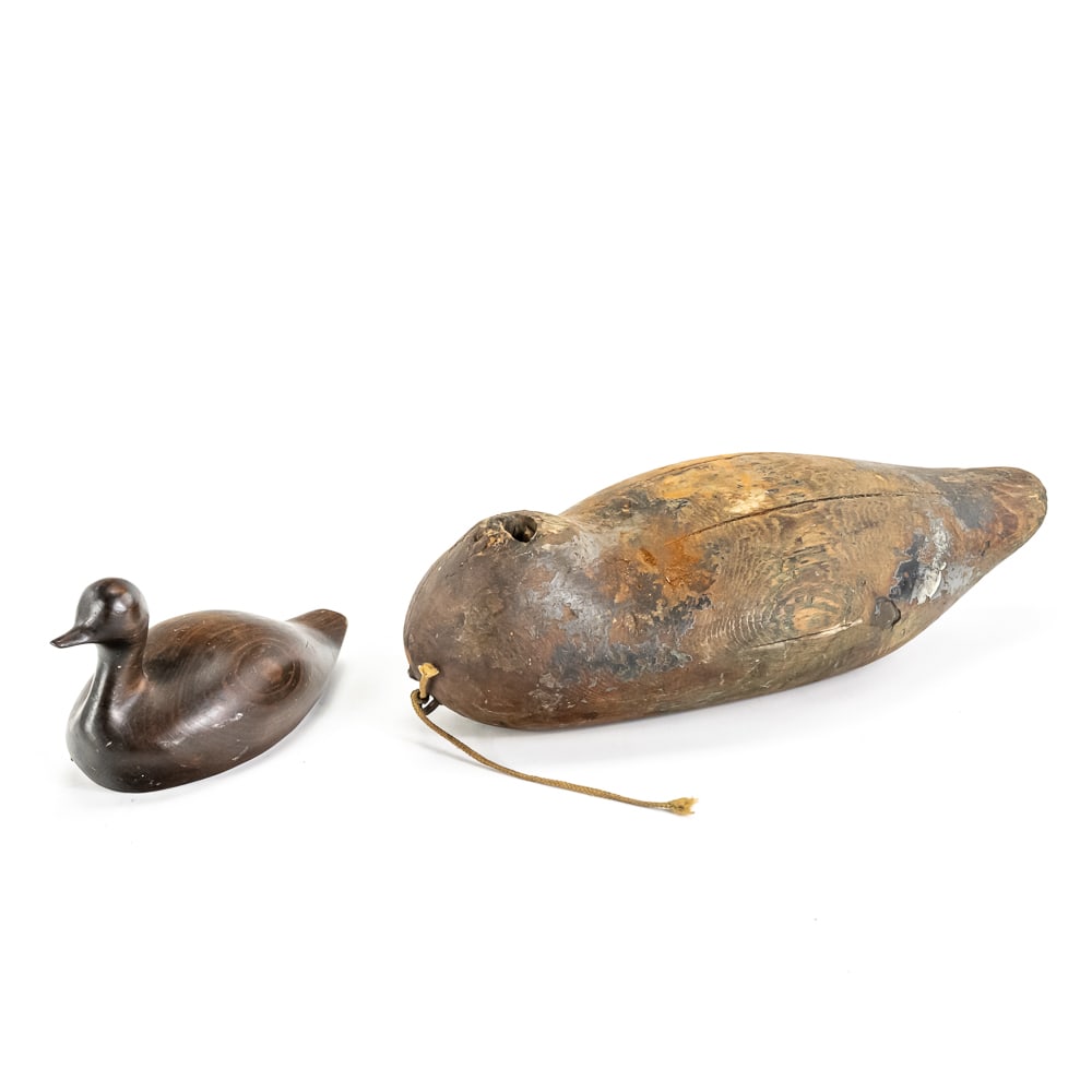 Vintage Florida Cypress & Primitive Decoys (2): This lot features two distinct wooden waterfowl decoys that tell a story of regional craftsmanship and utility. The smaller, more refined piece is a "hand-crafted in Florida" duckling made from