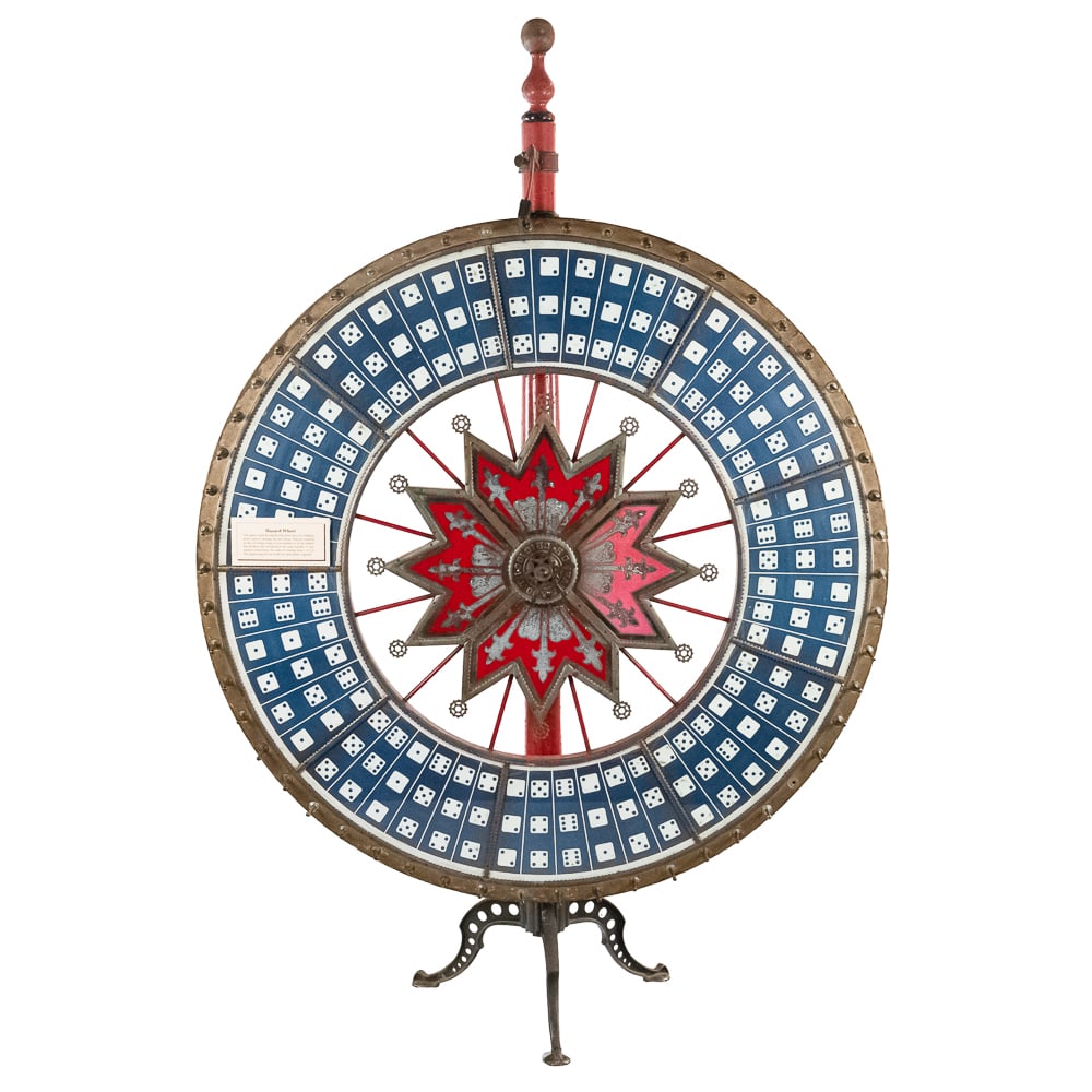 Antique HC Evans Jumbo Floor Model Gambling Wheel: Looks to be all original with a real good vintage look. Item shows a little wear on finish. This one has the nice finial top, fancy cast iron legs, good center glass and outer rim dice glass. Overall 