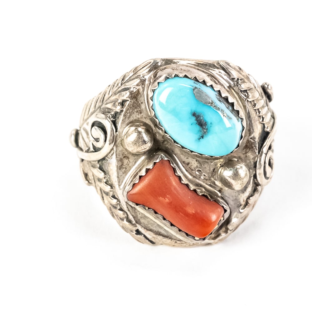 Vintage Navajo Coral & Turquoise Ring: This vintage Southwestern sterling silver bypass ring, heavily indicative of mid-to-late 20th-century Navajo craftsmanship, showcases a vibrant turquoise cabochon with a touch of dark matrix alongside